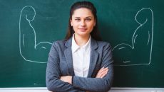 a serious young teacher near the board