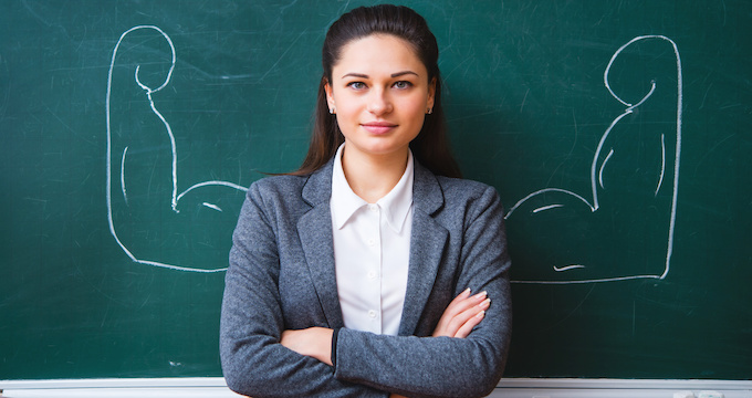 a serious young teacher near the board