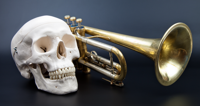 A skull and a trumpet representing the death of music and drama