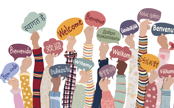 Hands holding cards with different languages on them